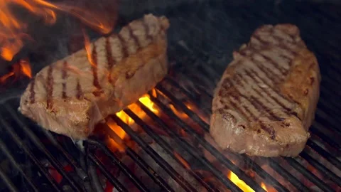 BBQ steak on grill. Grilling on open fire meat. Slow motion Stock Footage 156929001
