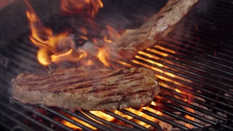 BBQ steak on grill. Grilling on open fire meat. Slow motion Stock Footage 156929232