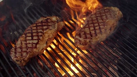 BBQ steak on grill. Grilling on open fire meat. Slow motion Stock Footage 156929799