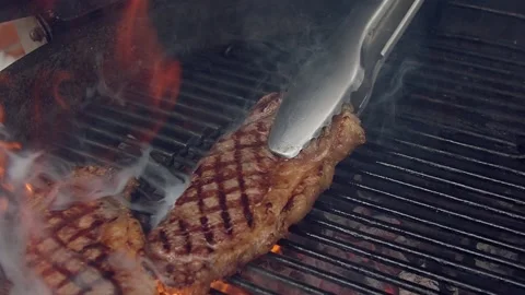 BBQ steak on grill. Grilling on open fire meat. Slow motion Stock Footage 156930733