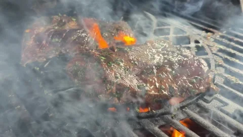 BBQ Steak Grilling on Hot Barbecue With Flames and Smoke Close-Up Stock Footage 311396018