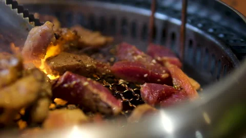 BBQ T-bone Steak Grilling over Open Fire with Flames and Smoke, 4K Slow Motion Stock Footage 326463754