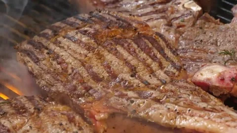 BBQ T-bone Steak Grilling over Open Fire with Roaring Flames and Smoke [1, 2] Stock Footage 338213153