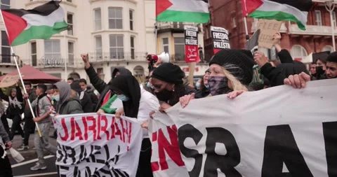 BDS Protest marching with Free-Palestine signs in the streets of Brighton, U Stock Footage 154425826