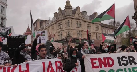 BDS Protest marching with Free-Palestine signs in the streets of Brighton, U Stock Footage 154426054