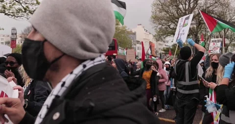 BDS Protest marching with Free-Palestine signs in the streets of Brighton, U Stock Footage 154426071