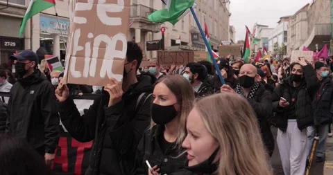 BDS Protest marching with Free-Palestine signs in the streets of Brighton, U Stock Footage 154426195