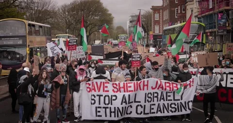 BDS Protest marching with Free-Palestine signs in the streets of Brighton, U Stock Footage 154426197