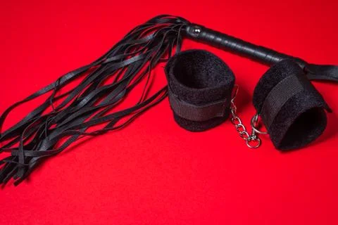 BDSM accessories on a red background.  Stock Photos