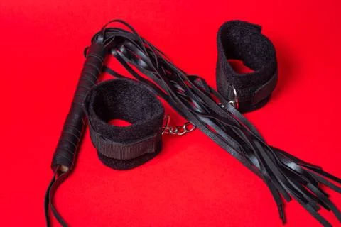 BDSM accessories on a red background.  Stock Photos