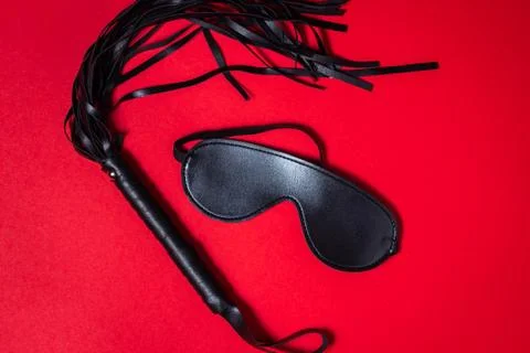 BDSM accessories on a red background.  Stock Photos