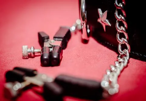 Bdsm accessory human collar and accessory nipple clasp with metal chain on a  Stock Photos