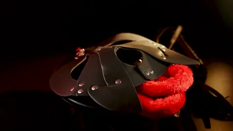 BDSM cat mask rotates on black background Stock Footage 305301784