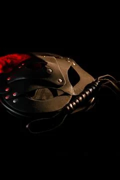BDSM mask resting on a dark surface with subtle hints of smoke Stock Photos