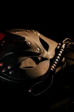 BDSM mask resting on a dark surface with subtle hints of smoke Stock Photos