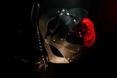 BDSM mask resting on a dark surface with subtle hints of smoke Stock Photos