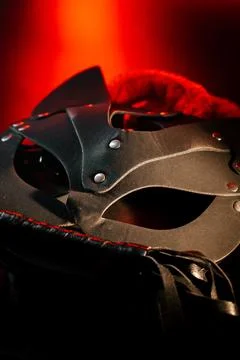 BDSM mask resting on a dark surface with subtle hints of smoke Stock Photos
