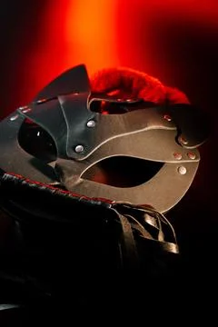 BDSM mask resting on a dark surface with subtle hints of smoke Stock Photos