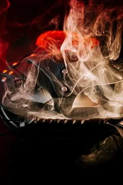 BDSM mask resting on a dark surface with subtle hints of smoke Stock Photos