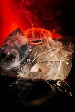 BDSM mask resting on a dark surface with subtle hints of smoke Stock Photos