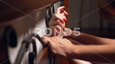 BDSM, sex toys. romantic couple in bed. the hands are handcuffed to the wrought Stock Photos