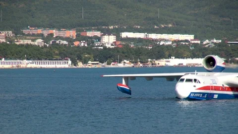 Be-200ES aircraft floats through water on background of Gelendzhik Bay. Stock Footage 124646601