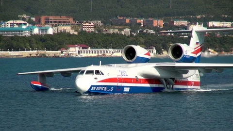 Be-200ES aircraft floats through water on background of Gelendzhik Bay. Stock Footage 125610258