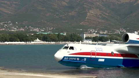 Be-200ES multi-purpose amphibian on chassis is taxiing from sea to shore. Stock Footage 132979691