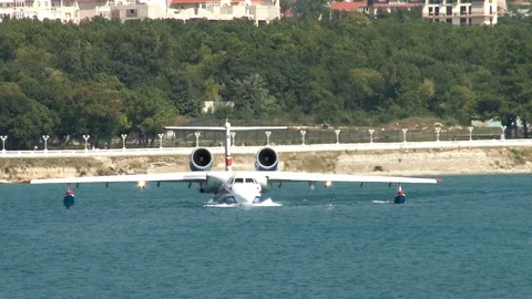 Be-200ES  multi-purpose amphibious aircraf unfolds and floats from coast. Stock Footage 121533025