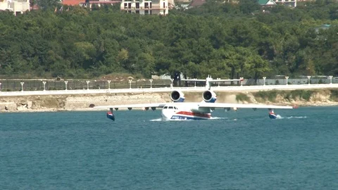 Be-200ES multipurpose amphibious aircraft floats like boat along coast. Stock Footage 121533005