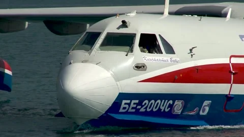 Be-200ES multipurpose amphibious aircraft floats like boat along coast of Bay. Stock Footage 132979588