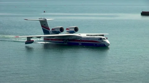 Be-200ES multipurpose amphibious aircraft floats like boat along coast of Bay. Stock Footage 134465262