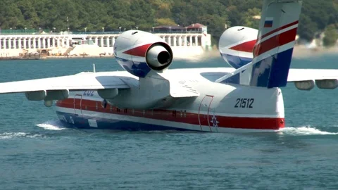 Be-200ES Russian multi-purpose amphibious aircraft floats like boat toward coast Stock Footage 121532963