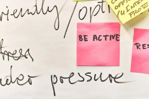 Be active written on pink paper stickers attached to a flip chart Stock Photos