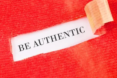 Be Authentic written under the torn paper on a white background Stock Photos
