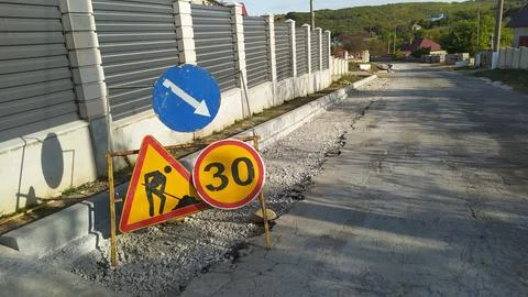 Be aware of the warning signs located on the under construction roadway for your Stock Photos