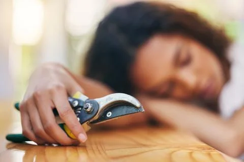 Be careful when using sharp objects. a tired nursery owner taking a break from 库存照片