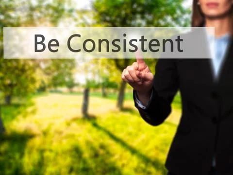 Be Consistent - Female touching virtual button. Foto stock