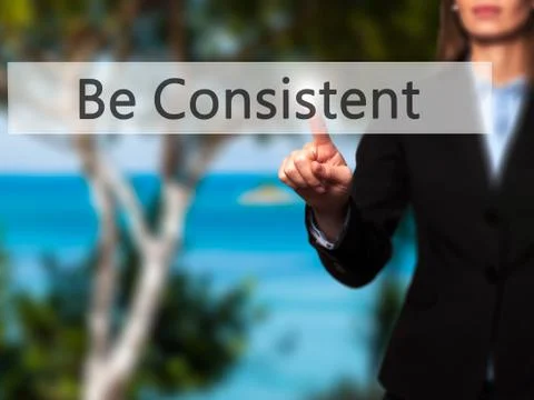 Be Consistent - Female touching virtual button. Foto stock