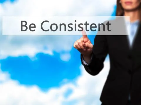 Be Consistent - Female touching virtual button. Foto stock