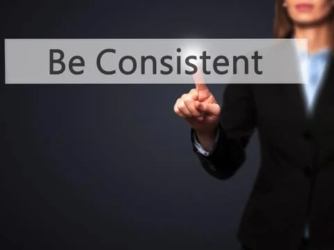 Be Consistent - Female touching virtual button. Foto stock