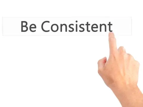 Be Consistent - Hand pressing a button on blurred background concept on visua Stock Photos
