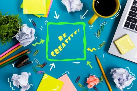 Be creative word. Office table desk with supplies, white blank note pad, cup Foto stock