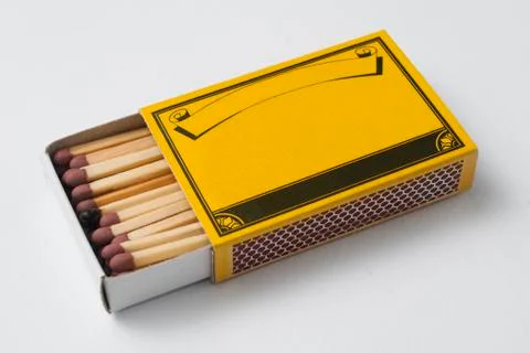 Be different concept: a blank yellow matchbox, with only one match burned Stock Photos