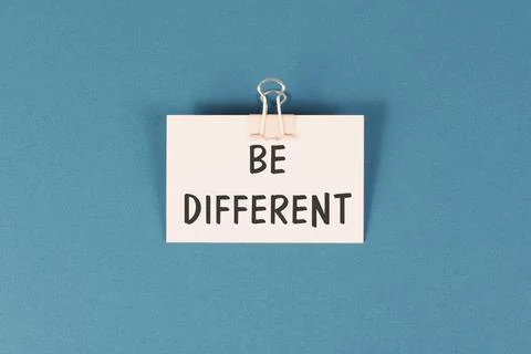 Be different is standing on the paper, make a difference, coaching and Stock Photos