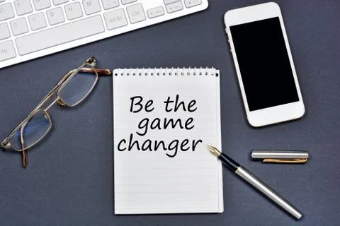 Be the game changer. Text on notebook Stock Photos