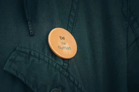 "Be the human" tittle on the button Stock Photos
