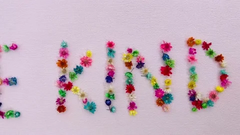 Be kind - card with words and colorful little flowers, motivation phrase on pink 스톡 동영상 208458317