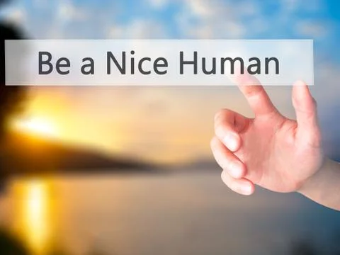 Be a Nice Human - Hand pressing a button on blurred background concept on vis Stock Photos