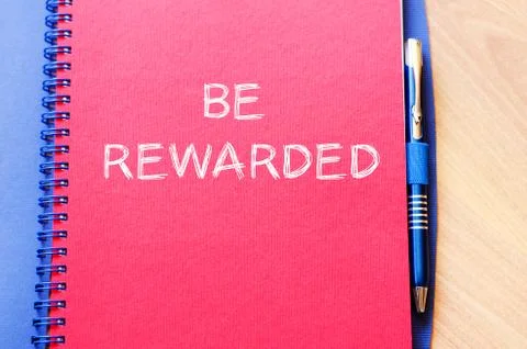Be rewarded write on notebook Stock Photos